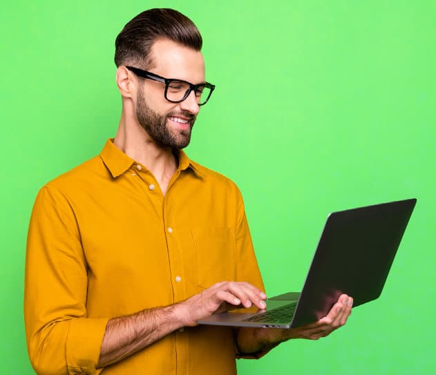 Man looking at laptop smiling